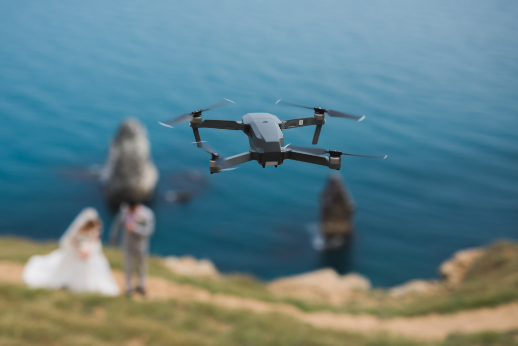 A drone capturing aerial views of a wedding ceremony, showcasing the creative potential of affordable used drones for aerial photography in 2025.