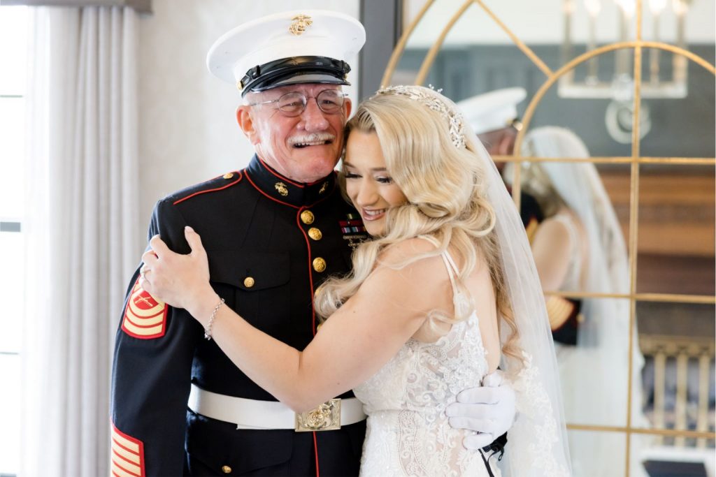 Bride hugging her teary-eyed father at the wedding, captured to showcase the emotional power of same-day wedding photo edits.