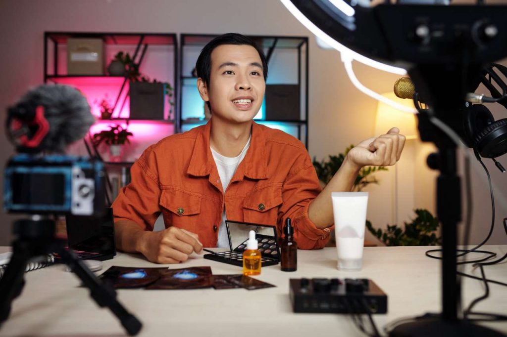 Asian content creator filming a TikTok video with one of the best used cameras for TikTok