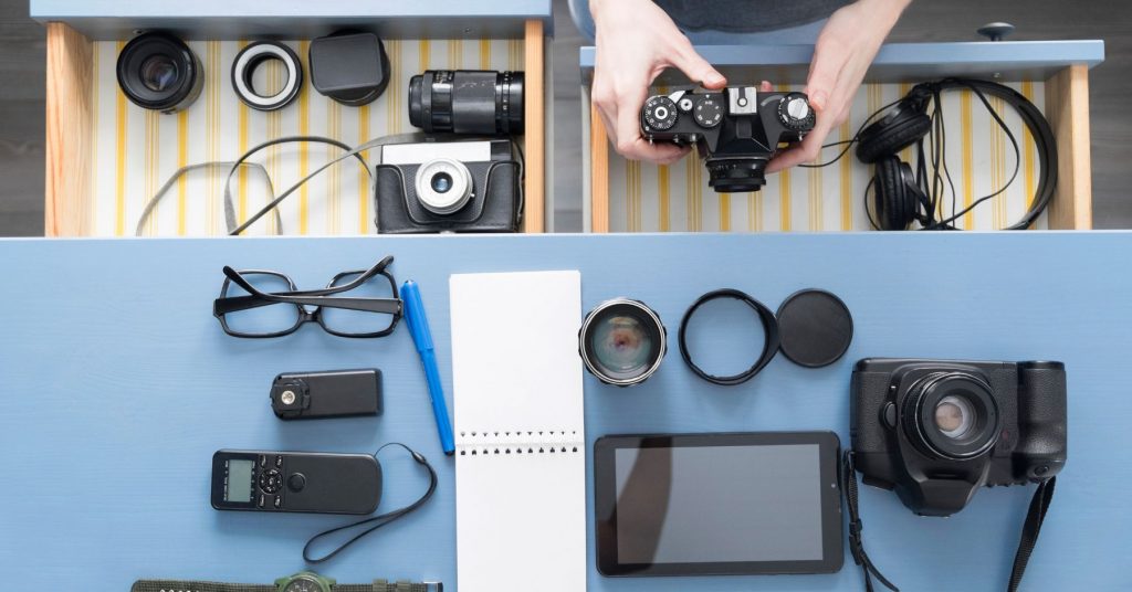 Creator organizing camera gear on a desk, preparing equipment for Black Friday deals for creators.
