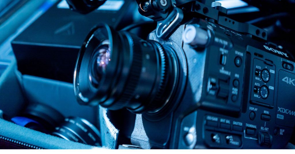 Cinema camera rig with cine lens under blue lighting, featured in Black Friday deals for creators upgrading their filmmaking setups.