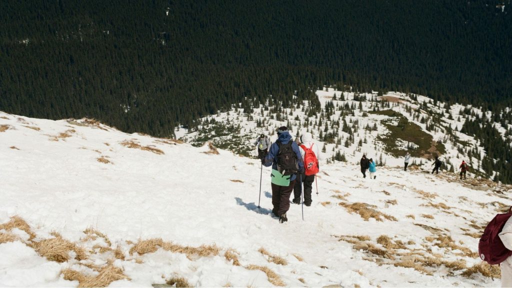Photographers hiking through a snowy landscape, illustrating intentional, slower creative choices tied to the question Film Ricoh GR Actually Possible.