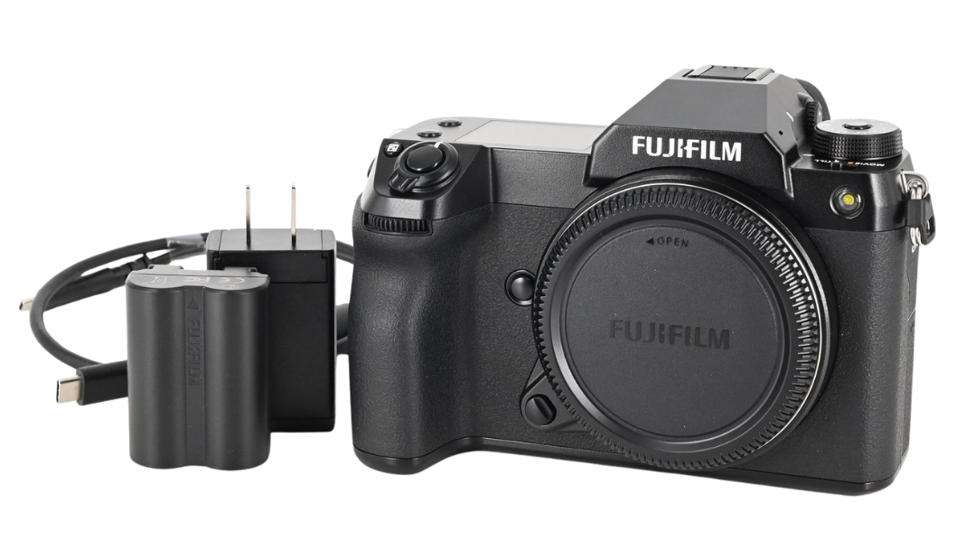 Fujifilm GFX medium format mirrorless camera body with battery, USB-C charger, and power adapter — What Your Go-To Camera Brand Says About You