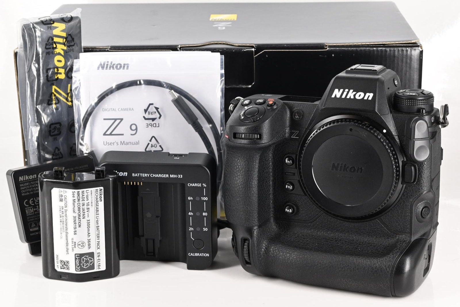 Nikon Z9 used camera body with original box, EN-EL18d battery, MH-33 battery charger, and user's manual — complete kit listing on GearFocus